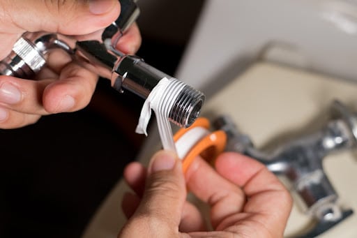 plumbers-tape Working plumber install faucet.