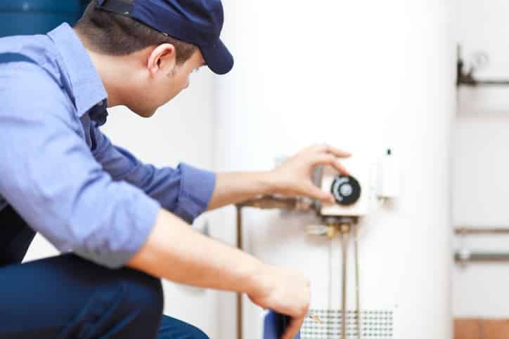 Plumber looking at water heater