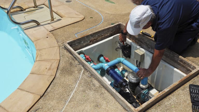 Technician repairing a residential pool pump